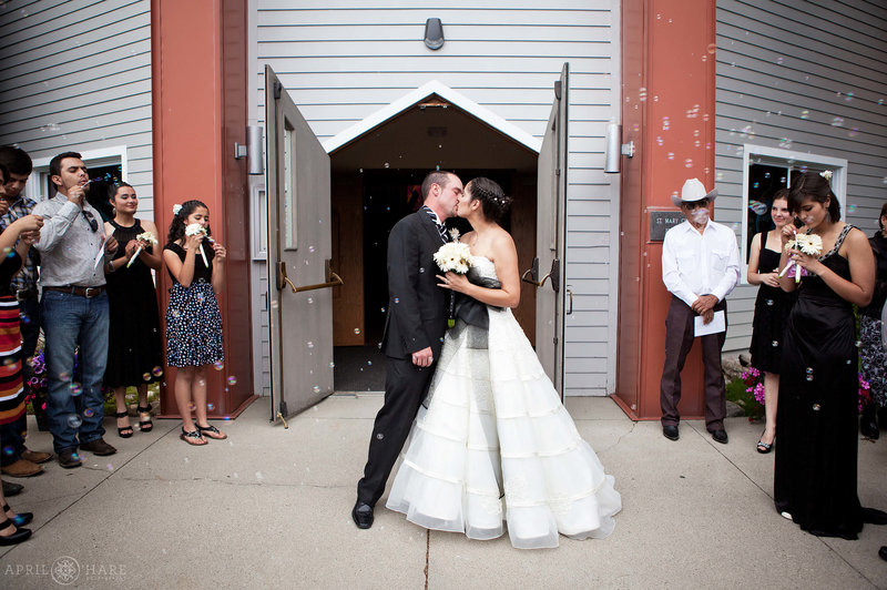 Couple kiss outside of the modern section of St. Mary's Catholic Church in Breckenridge CO