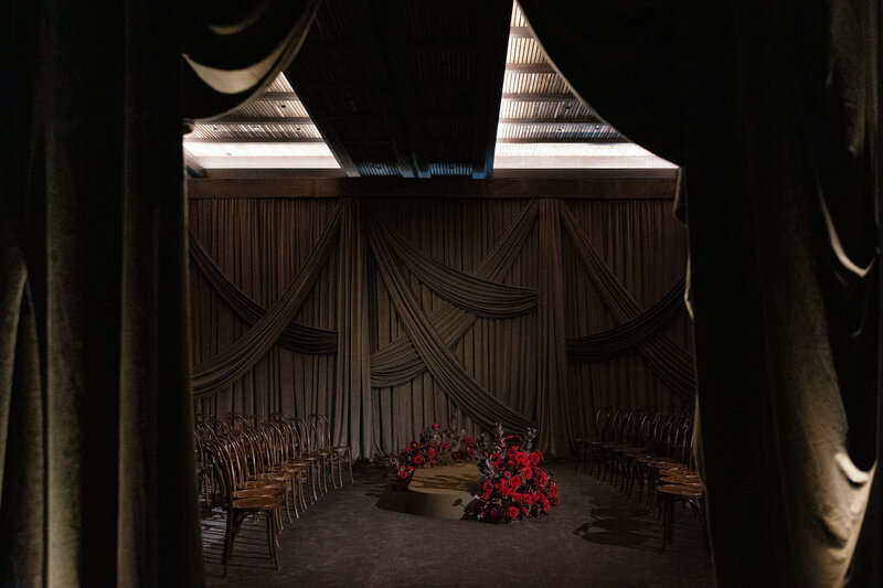 Bride in white lace wedding dress against black background at Lake Como Wedding