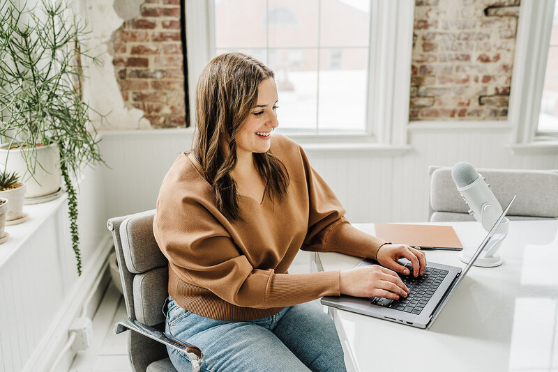 woman working on laptop during brand photoshoot