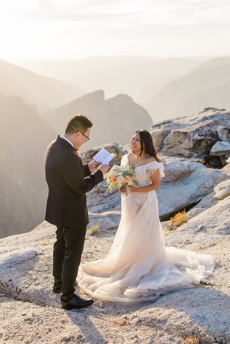 bride and groom read their personal vows to each other during their ceremony for their Yosemite elopement.