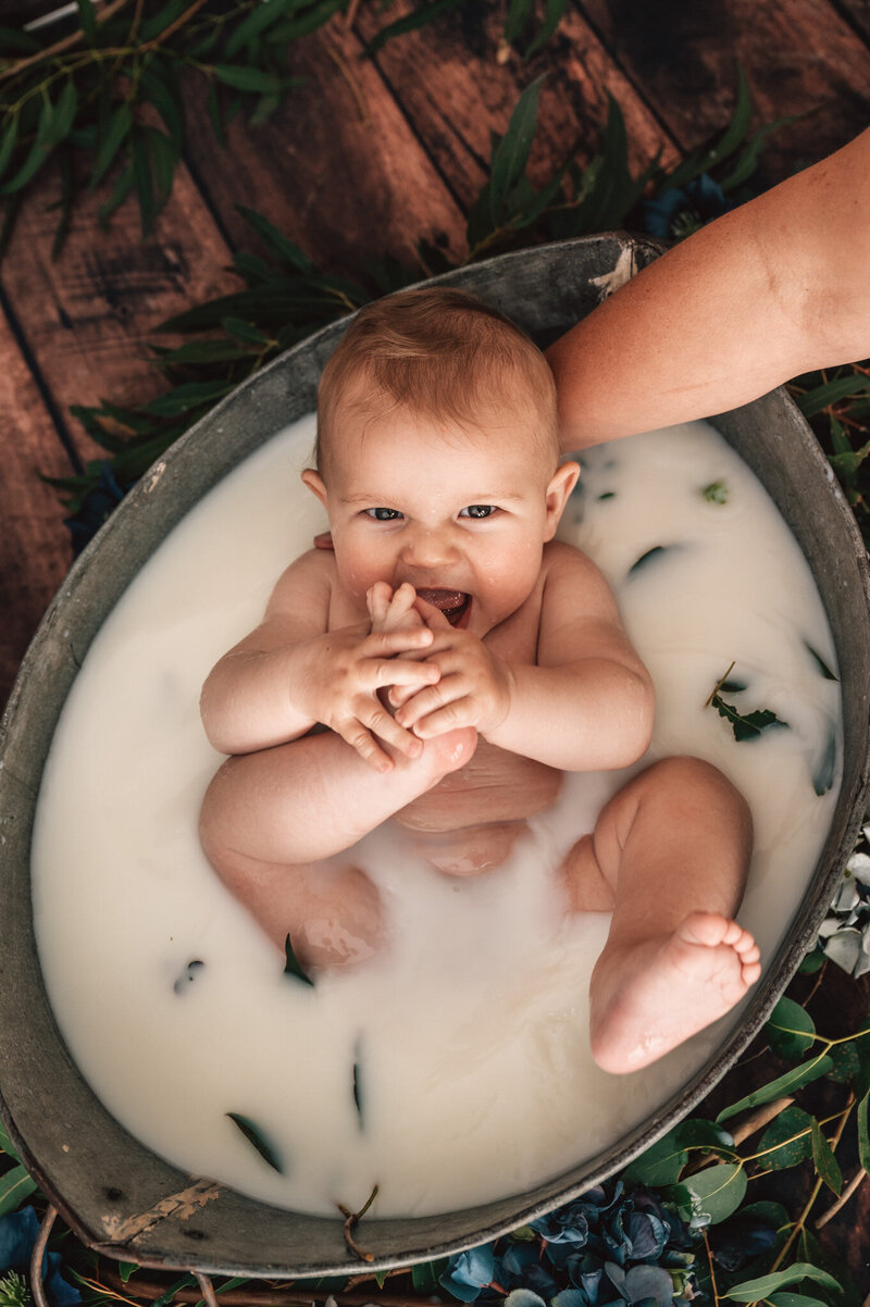boy eating his toes in milkbath