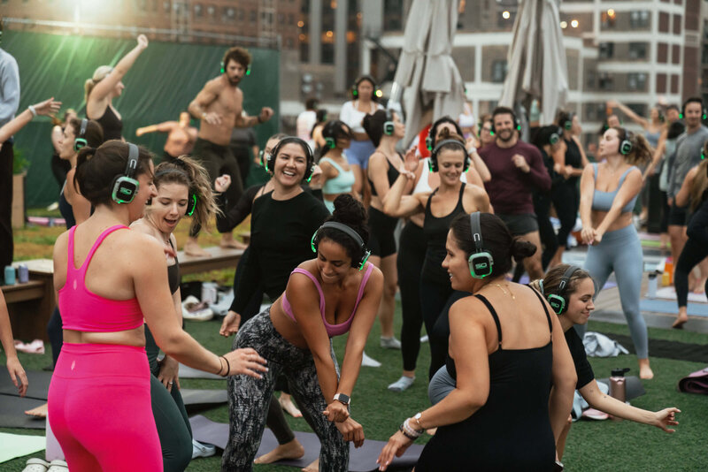group of women dancing during a deep house yoga session