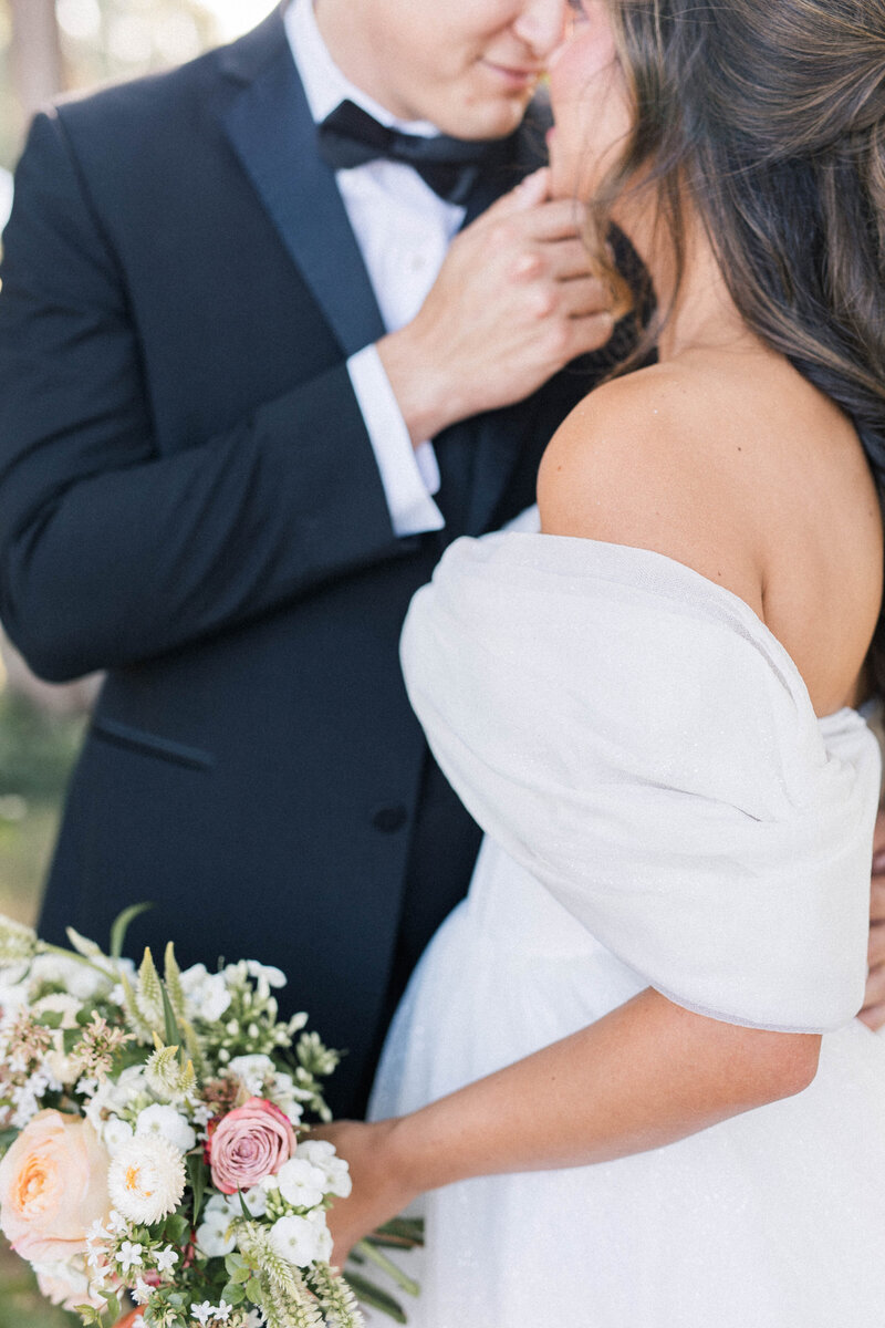 Classic Knoxville bride holding flowers and groom holding brides chin at marblegate farm
