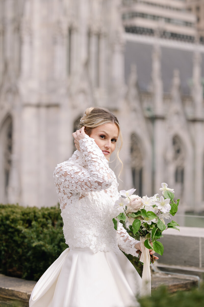 candid image of a bride holding her hair at 620 loft and gardens in NYC