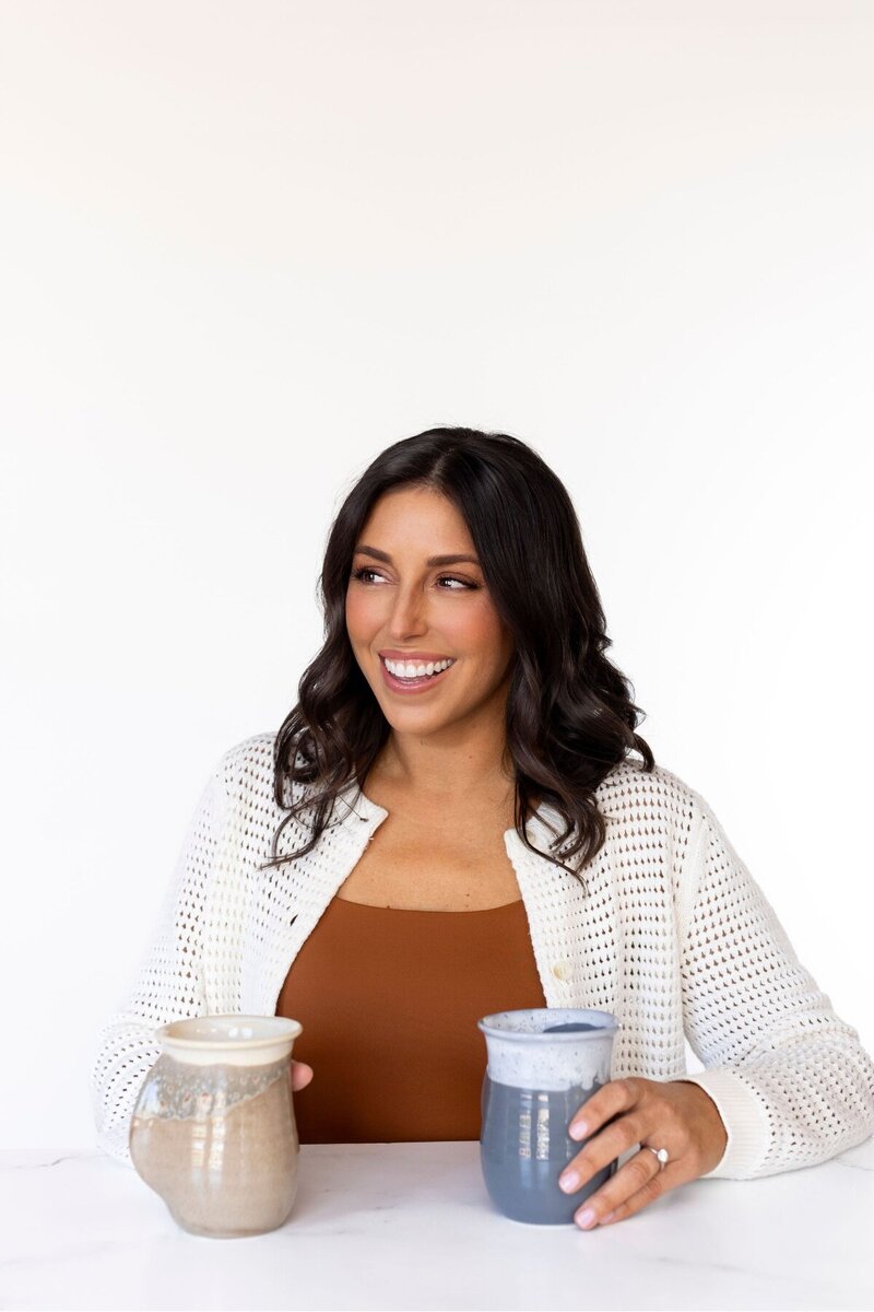 Victoria - Founder - Smiling with coffee in hand