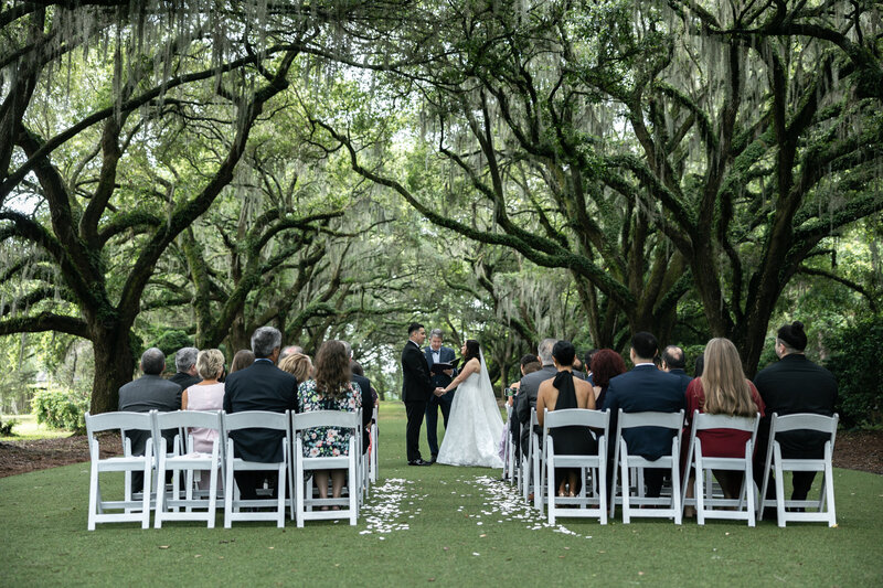 black and white shot of bride getting ready with makeup artist