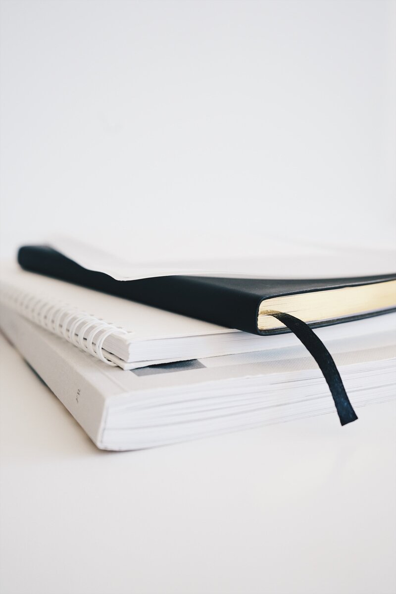 a stack of notebooks against a white background
