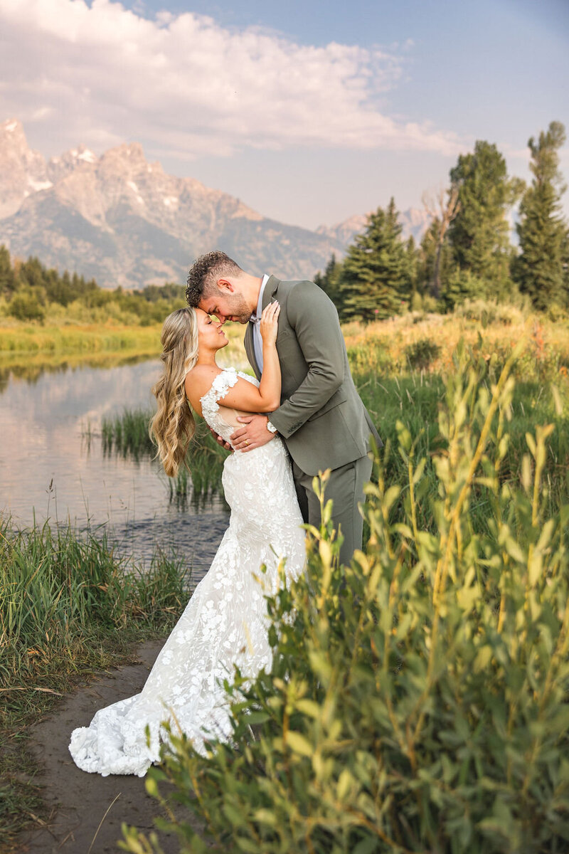 Photo of Bride and Groom embracing at Schwabacher Landing  In Grand Teton National Park in Jackson Wyoming taken by PIttsburgh Wedding Photographer, Sara Haines