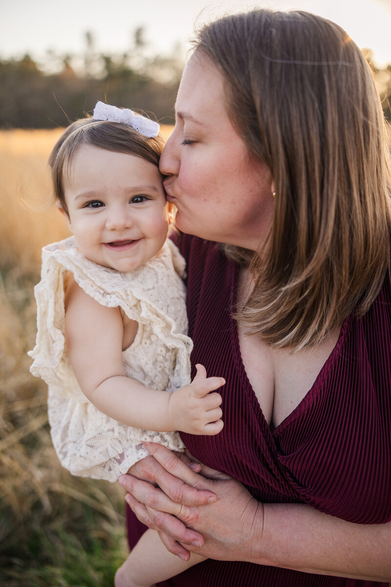 Soon to be family of four capturing a sweet moment together during their family session at sunset with molly berry photography | your augusta family photographer
