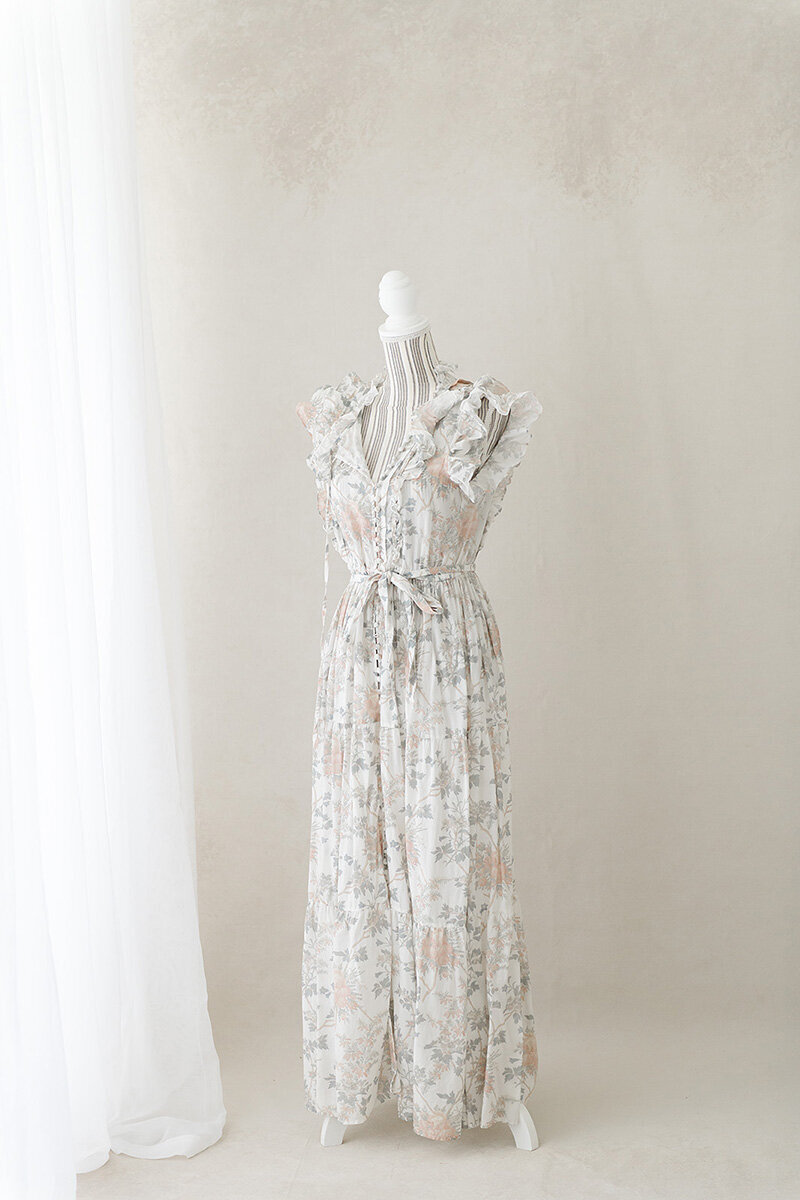 Floral dress on mannequin from Andrea Krey’s client wardrobe for maternity and family photography in Destin, FL