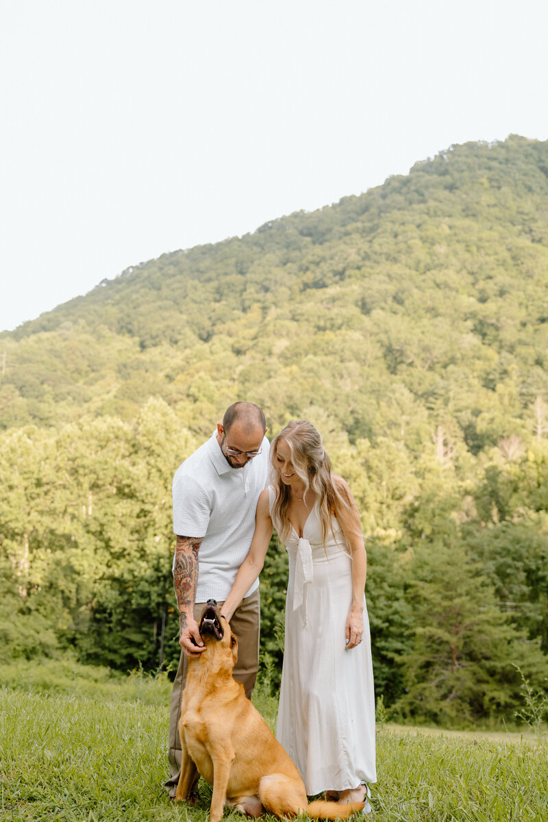 couple petting their dog