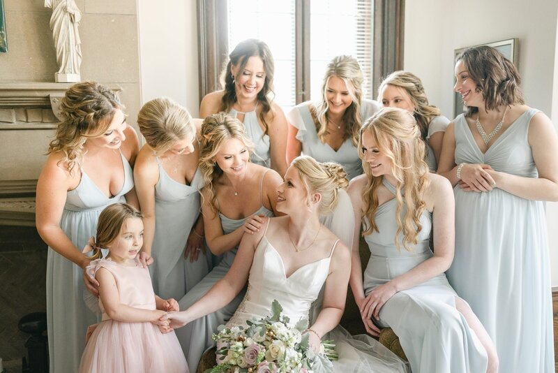 bride surrounded by wedding attendants