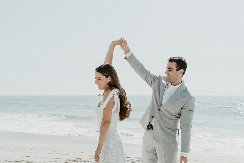 bride and groom dancing on beach at wedding in Santa Monica
