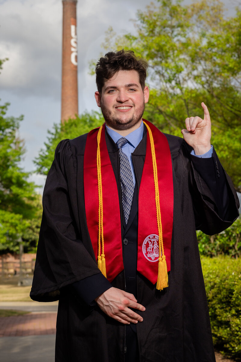 A University of South Carolina student taking his senior portraits on campus