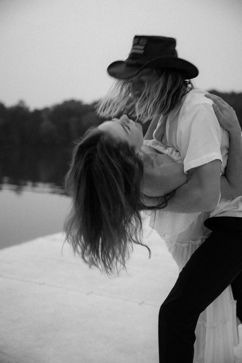 Man in cowboy hat dips woman in dance move while on a dock at Percy Priest Lake in Nashville, TN.