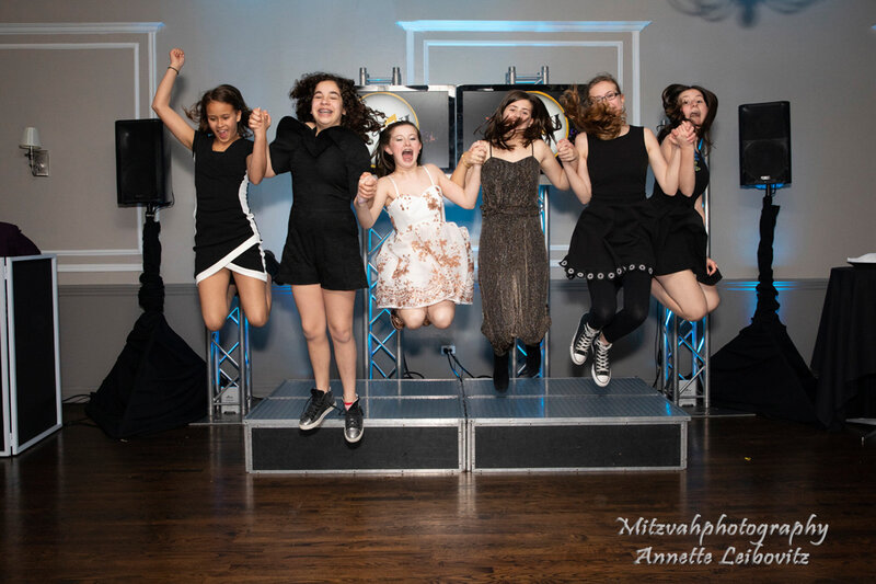 Group of girls jumping on stage at party