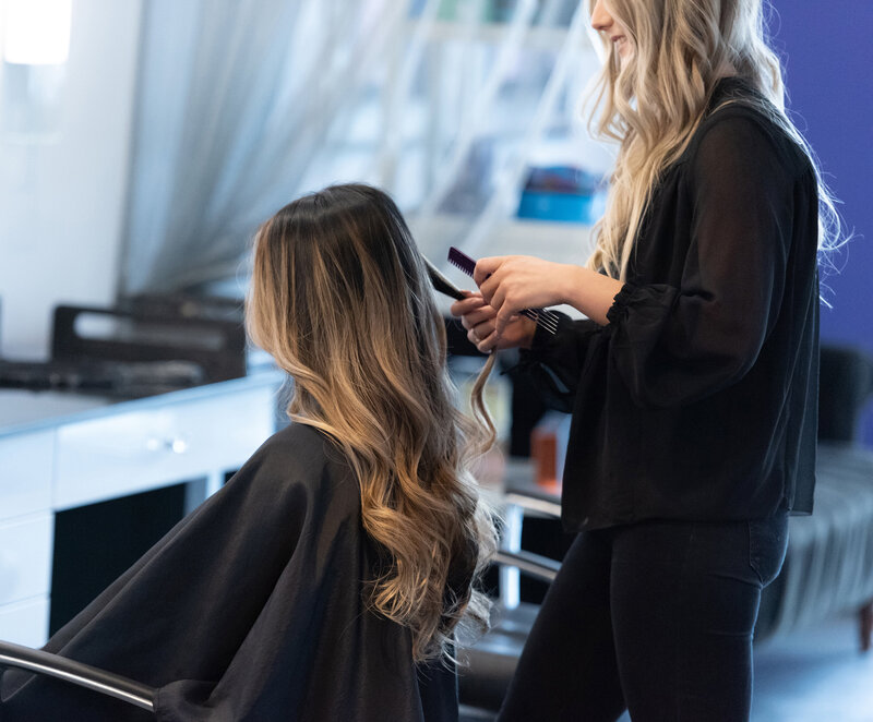 Stylist and client with long hair