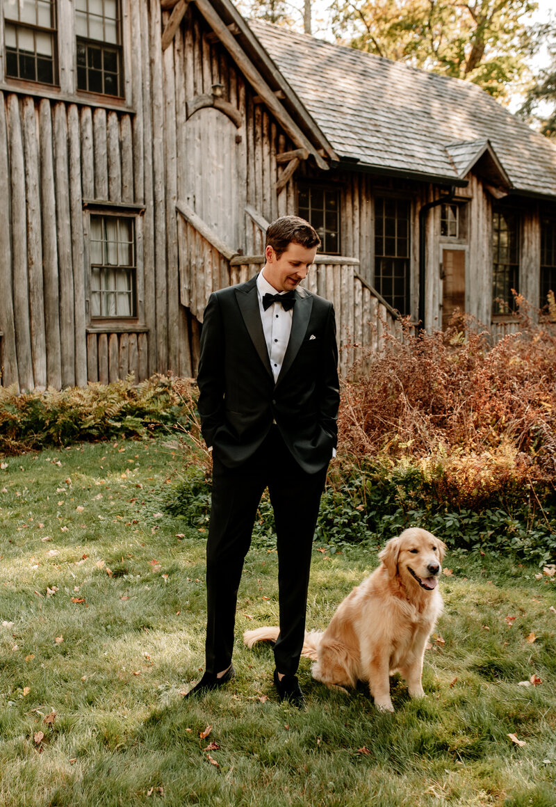 Groom's golden retriever loyally sits next to him as they await a first look with the bride.