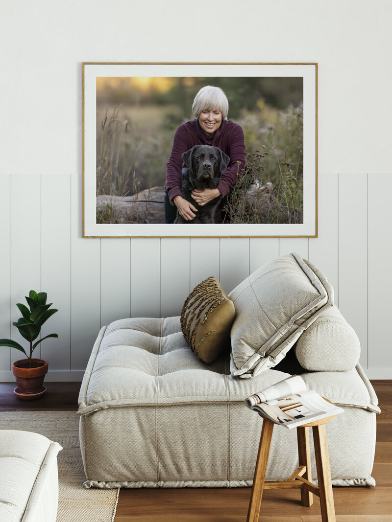 wall art of a woman hugging her black lab