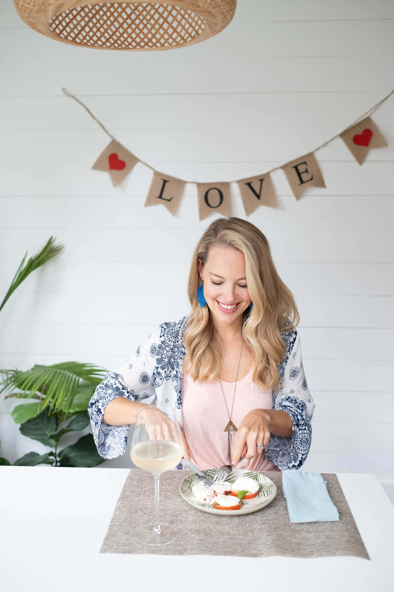 A healthy mom enjoying her food with wine 