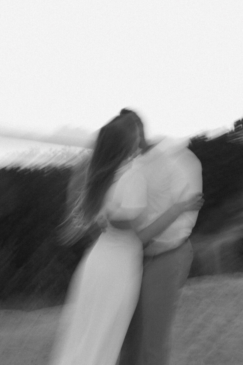 Bride and groom sharing a romantic moment in a mountain meadow during their intimate Grand Teton wedding, photographed by Seattle destination wedding photographer Rachael Marie Photography