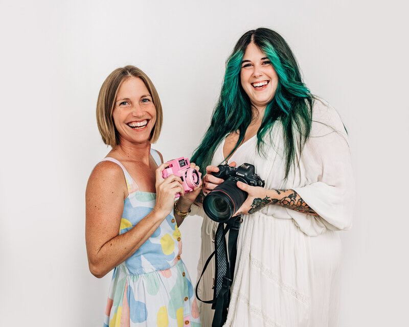 Alison and Samantha hold camera's together taking st pete family photography
