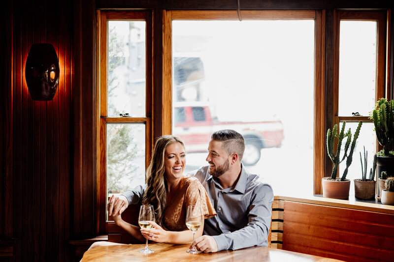 couple laughing with wine