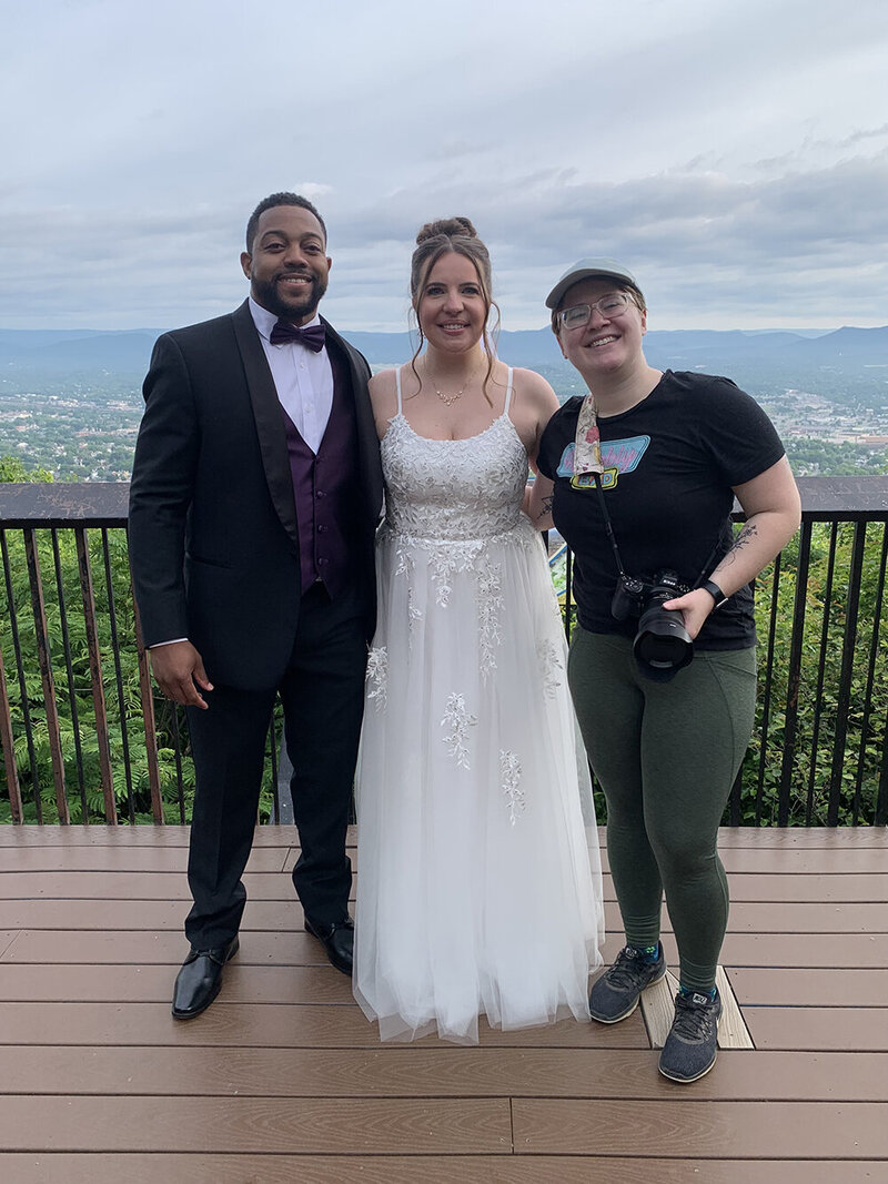 A bride and groom on their elopement day "clink" their rings together during a ceremony in front of the Moss Arts Center at Virginia Tech in Blacksburg, Virginia.