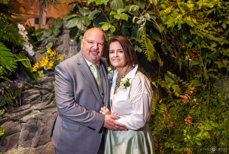 Tropcal plant backdrop couples portrait at Marnie's Pavilion at Denver Botanic Gardens