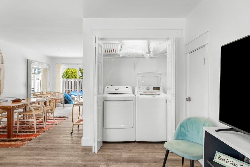 Convenient laundry closet with washer and dryer, located just off the main living area—perfect for extended beach vacations.