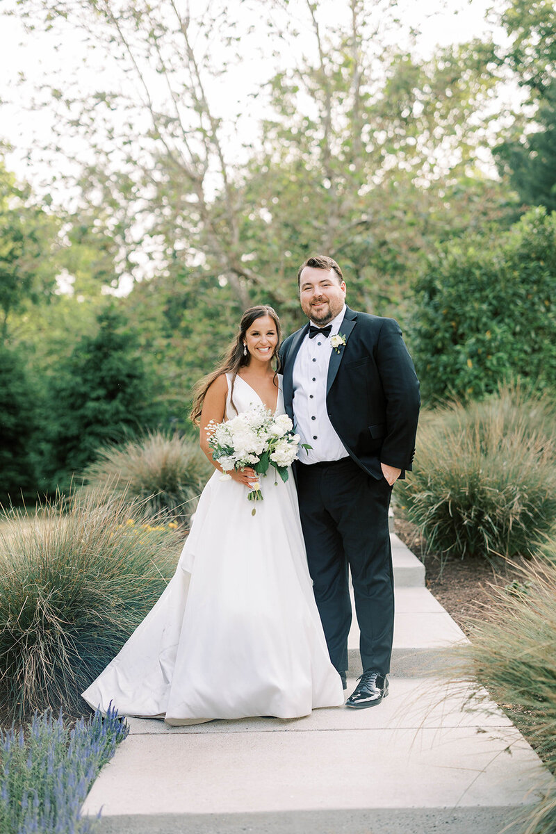 Bride and groom smile together in summer wedding at the Historic Acres of Hershey In Elizabethtown, PA