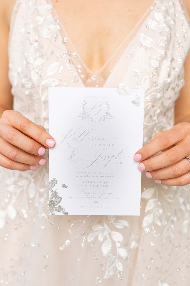 bride holding custom wedding invitation