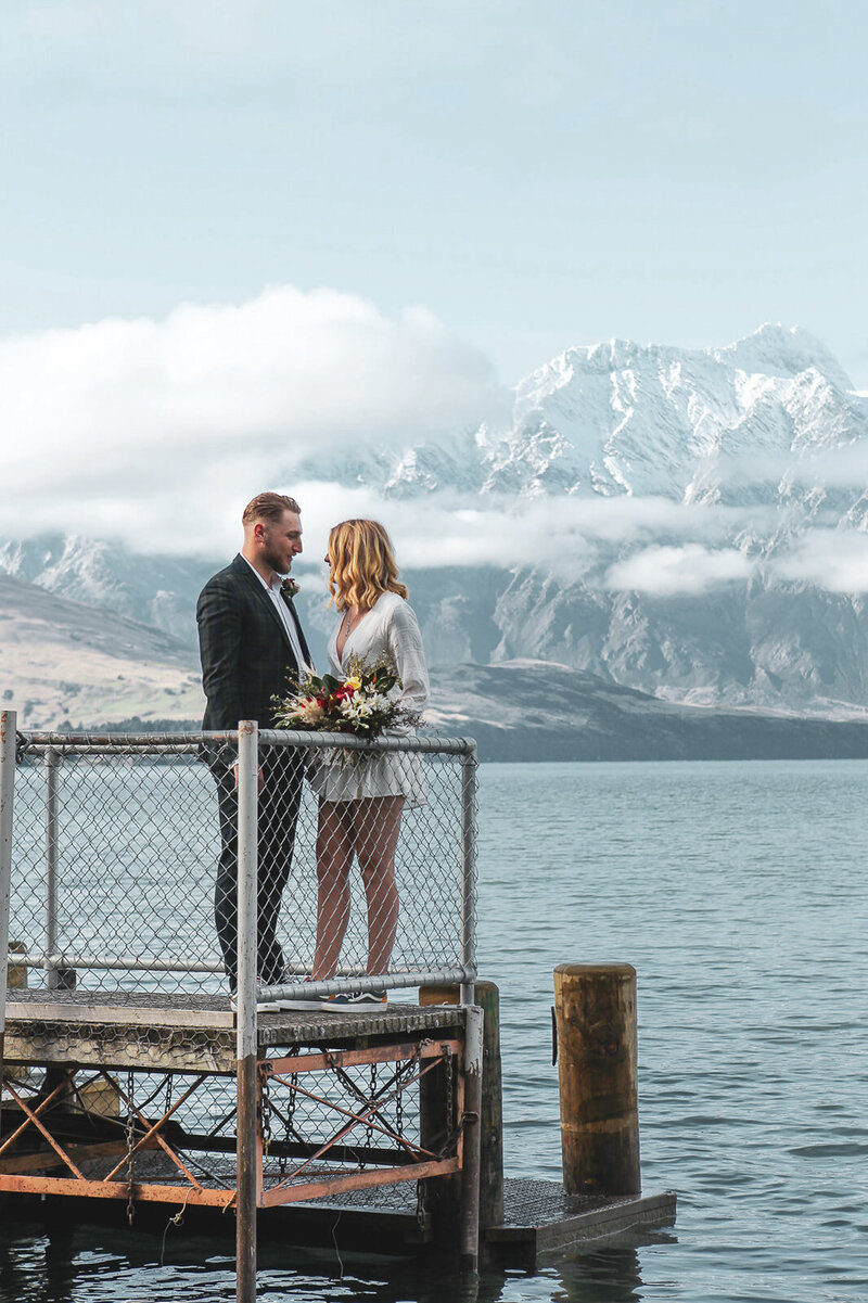 couple pose by mountains