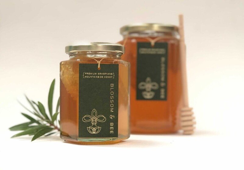 Two glass jars of honey with  beautiful label design