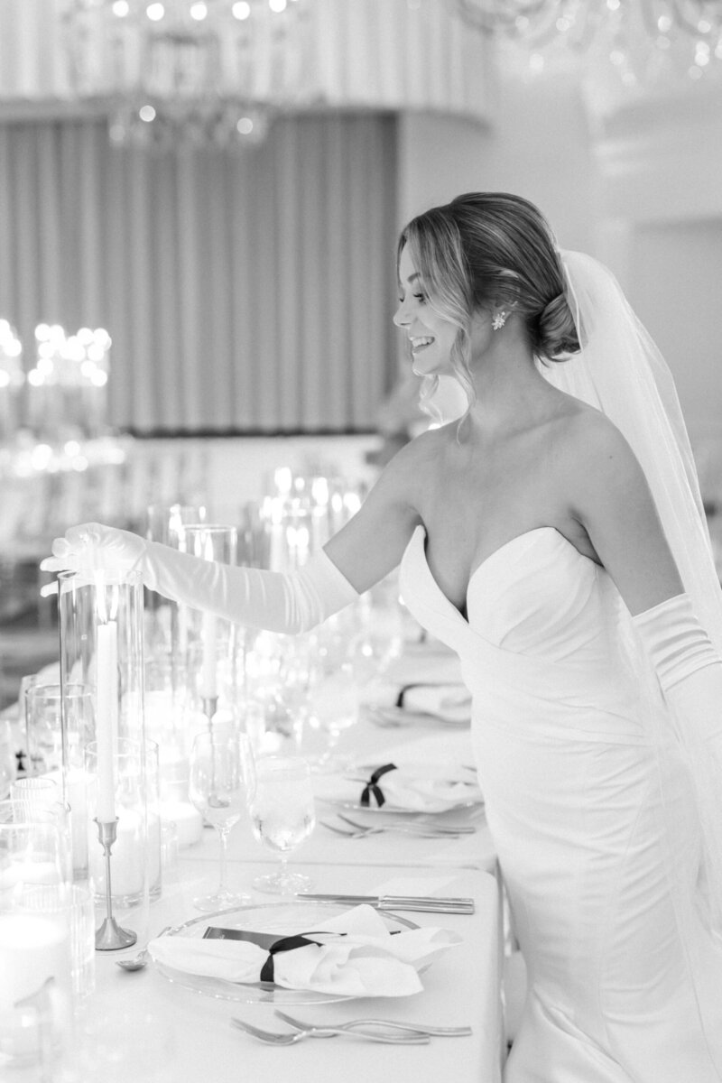 Bride at candlelit banquet table at Hotel del Coronado, designed by Thater Made, a luxury wedding and event producer in San Diego, CA.
