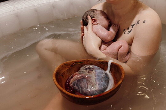 Couple posing in their home during an in home newborn photoshoot