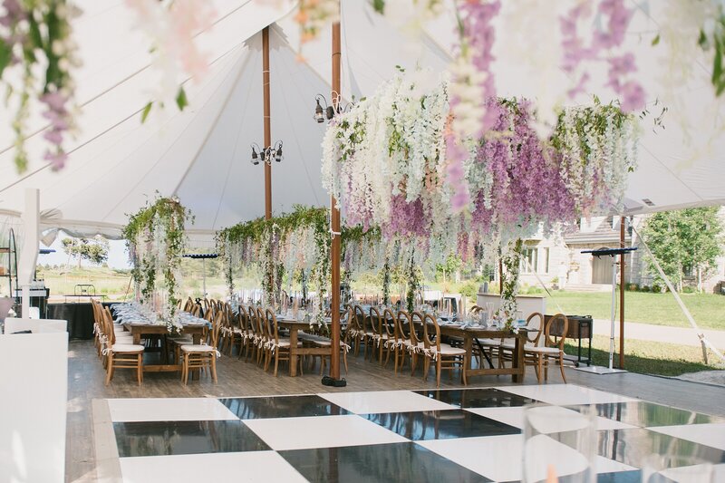 Colorado wedding photographer, Shelly Anderson, photographed a beautiful reception tent filled with garden florals draped from the ceiling