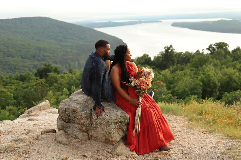 Married couple celebrating their anniversary at the top of a mountain with boho florals
