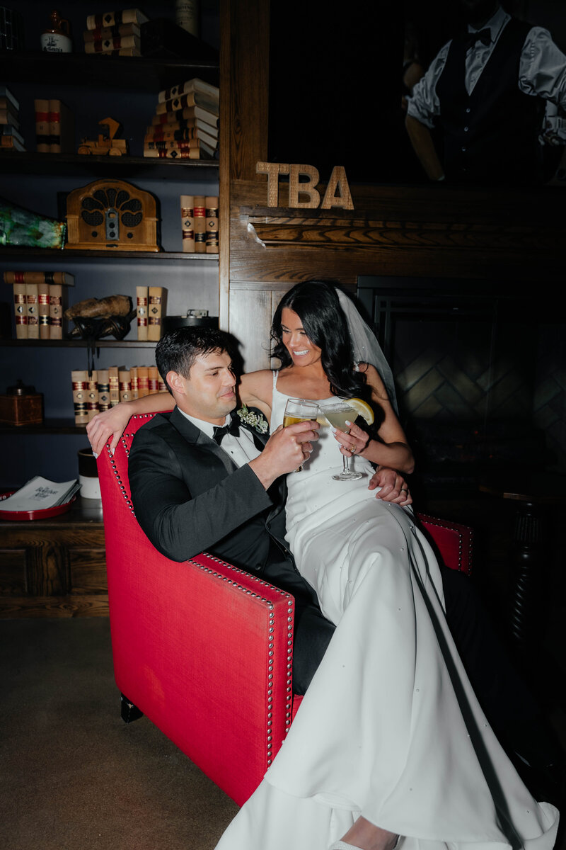 Ohio wedding photographer capturing candid bride and groom portraits at an indoor bar lounge, perfect for couples wanting unique and stylish Midwest wedding memories.