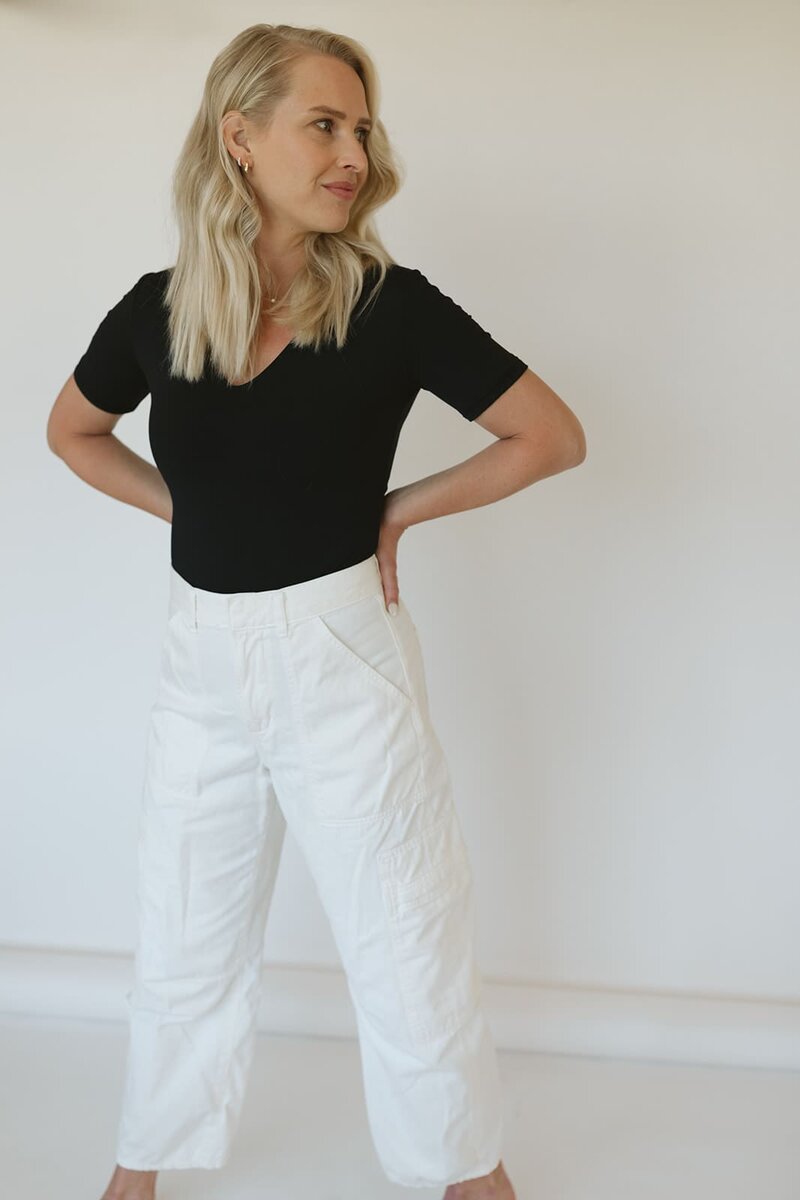 Lauren, founder of Studio Only You, standing in a minimalist space with a soft, grounded expression
