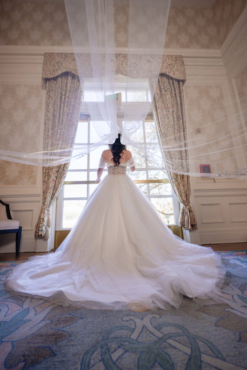 Bride walking out and veil in the air 