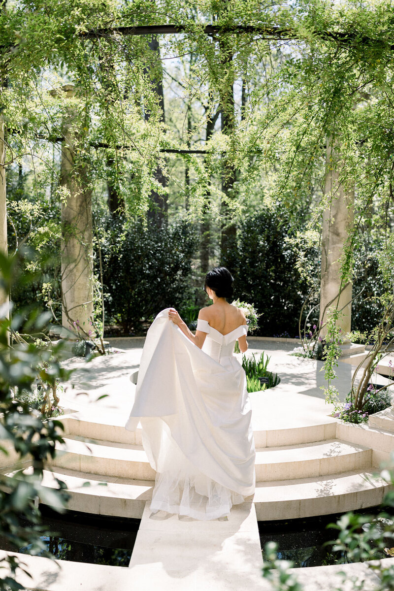 Asian bride walking through the gardens at the Swan House in Buckhead