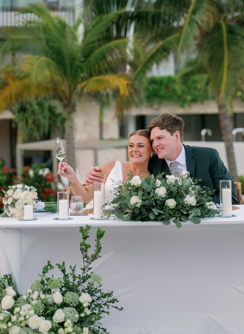 A newly married couple enjoys their tropical outdoor wedding reception in Cancun