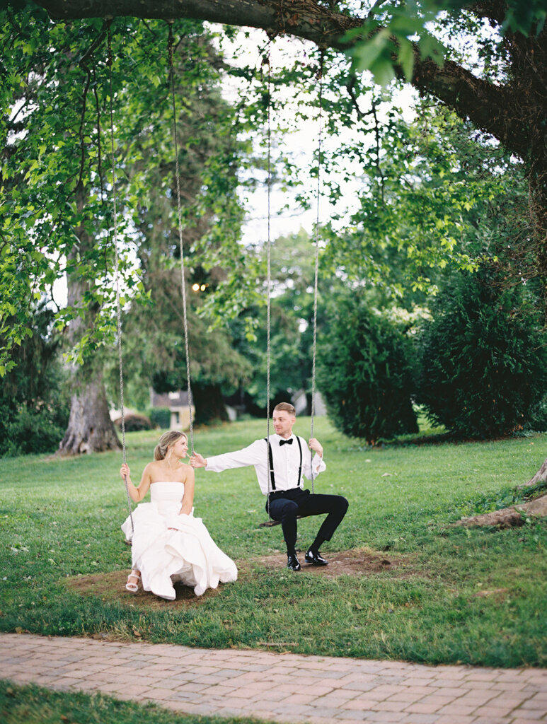couple playing on swings together  taken on film by film wedding photographers nicole simensky