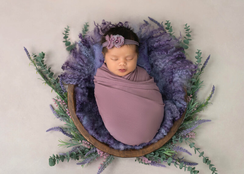 A fine art photography portrait hangs above a changing table in a nursery