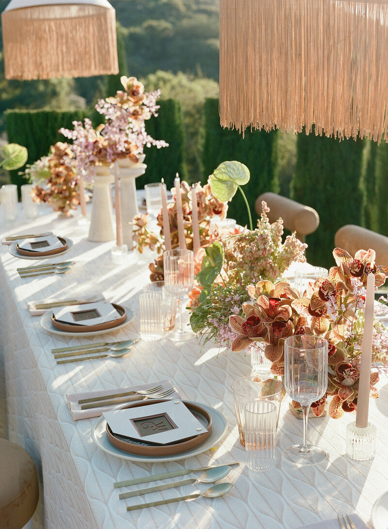 Pink and raspberry luxury Ginori china with yellow florals for a welcome dinner in Tuscany