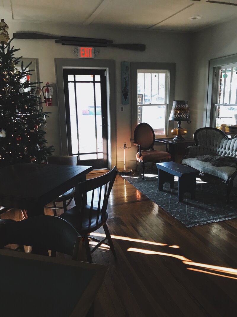 Hillcrest Coffee's Main Space decorated with holiday decor and natural light shines through the windows