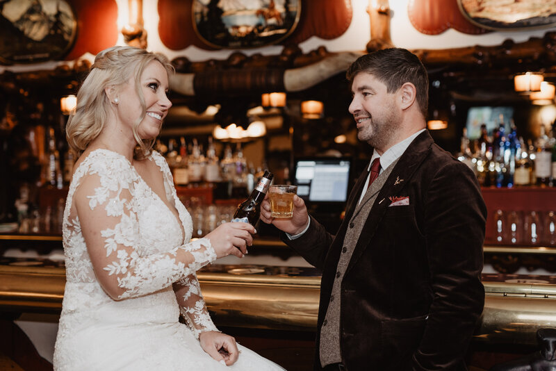 jackson hole photographers photographs bride adn groom at a bar in downtown jackson hole to celebrate their wyoming elopement
