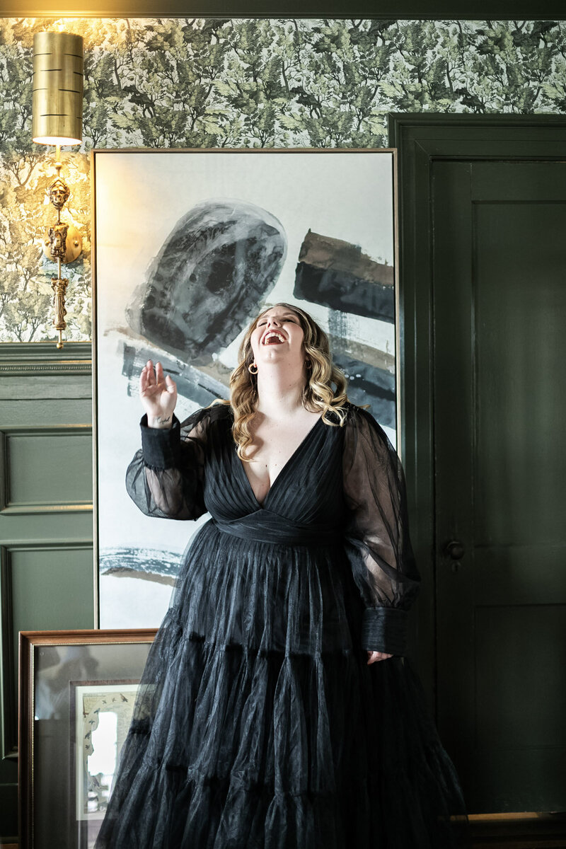 Ashleigh Henry, life coach for high-achieving women, standing in a black gown in Asheville, NC — embodying slow success, sacred leadership, and emotional clarity.