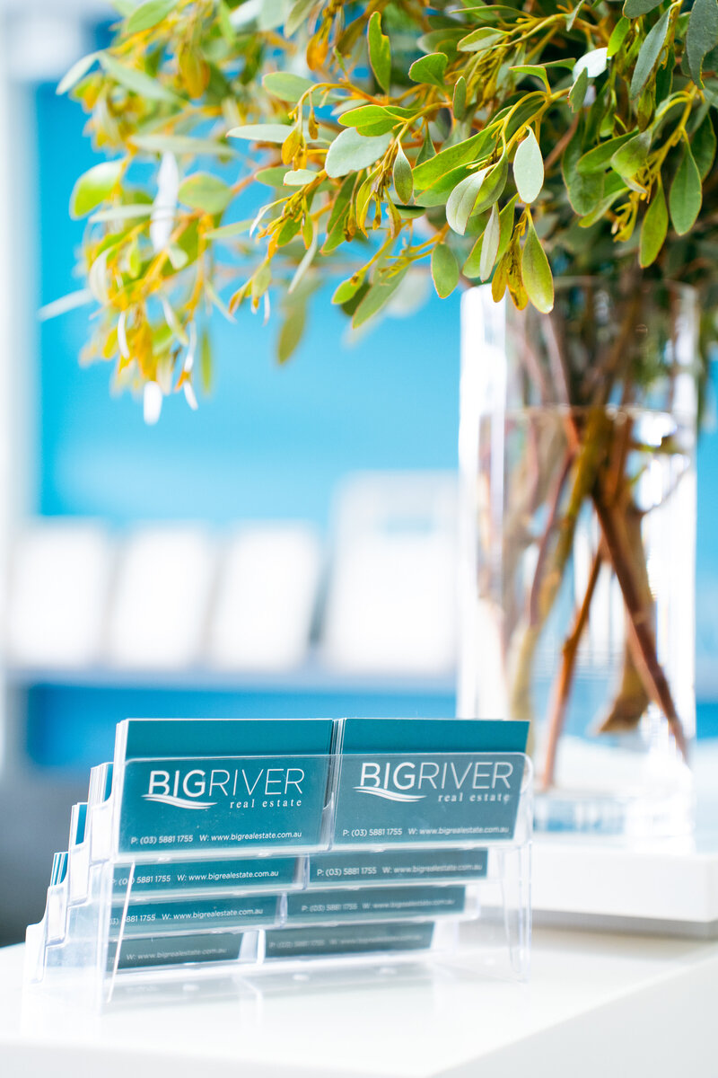 Branded business card display for Big River Real Estate.